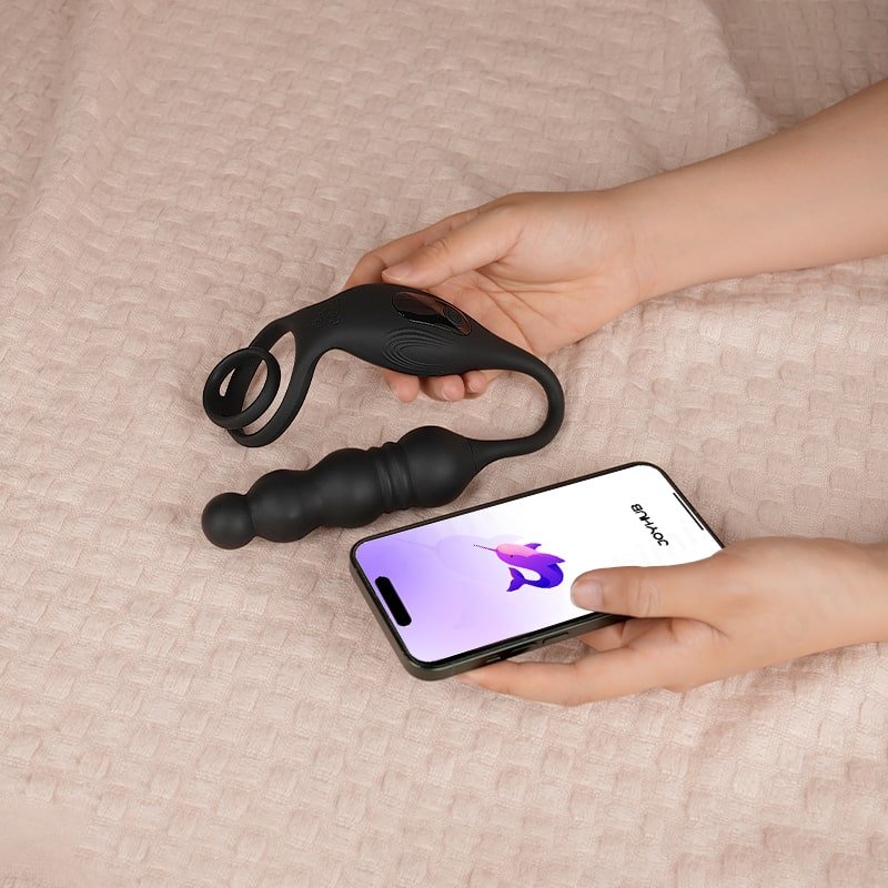 A hand hold a anal butt plug toy with a phone app joyhub