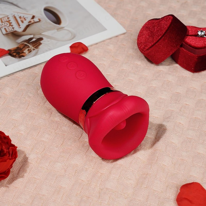Red tongue vibrator on a blanket with a ring box and a book