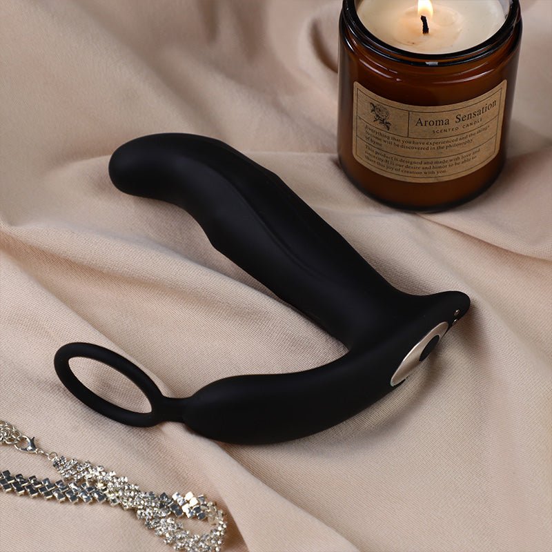 Black silicone wand with a lit candle labeled 'Aroma Sensations' on beige fabric.