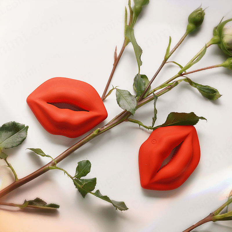 Red lip-shaped objects on a white background with green leaves.