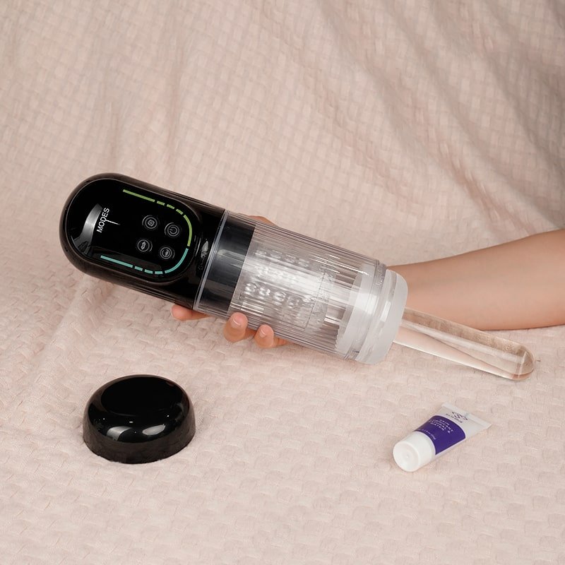 Person holding a black and clear male masturbator