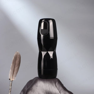 Black Suction and Vibrating male masturbator with a feather on a gray background