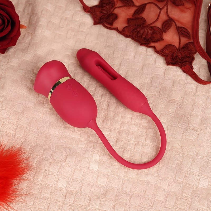A red G - Spot Clit Stimulator on a pink blanket with some decorations