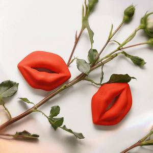 Red lip-shaped objects on a white background with green leaves.